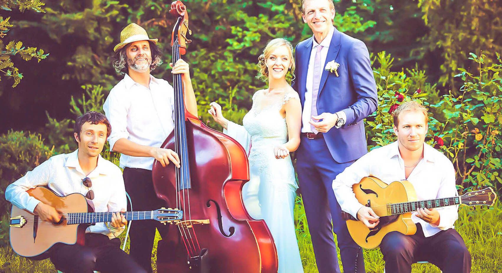 Bride and groom with Cordes Nomades gypsy jazz musicians at their wedding in the South of France